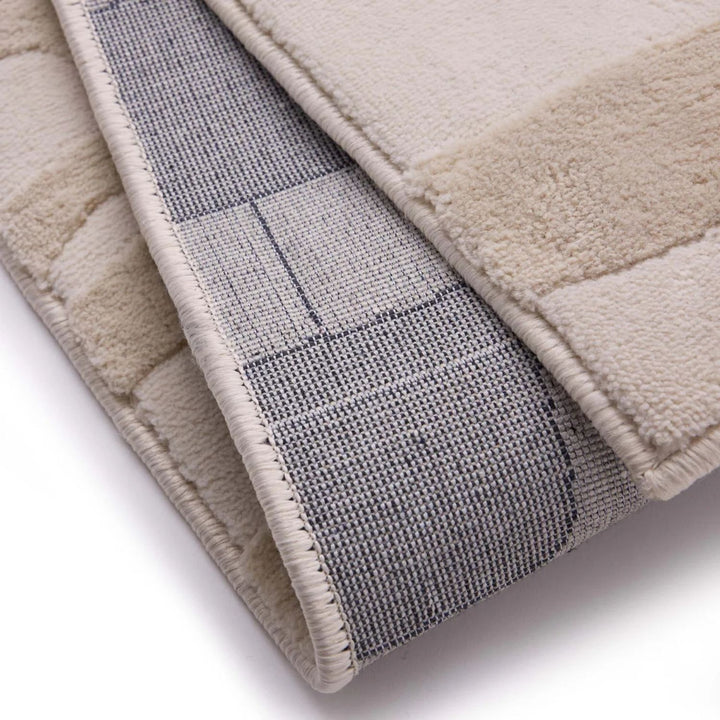 Close-up of a textured rug with a checkered pattern on a white background