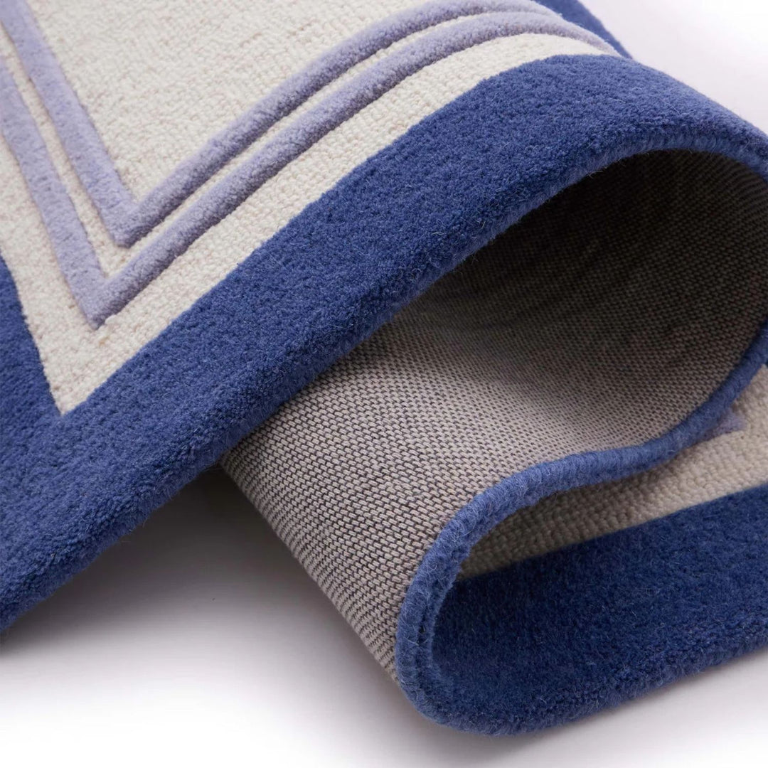 Close-up of a blue and gray patterned rug on a white background