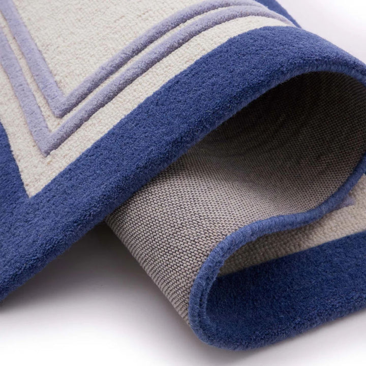 Close-up of a blue and gray patterned rug on a white background