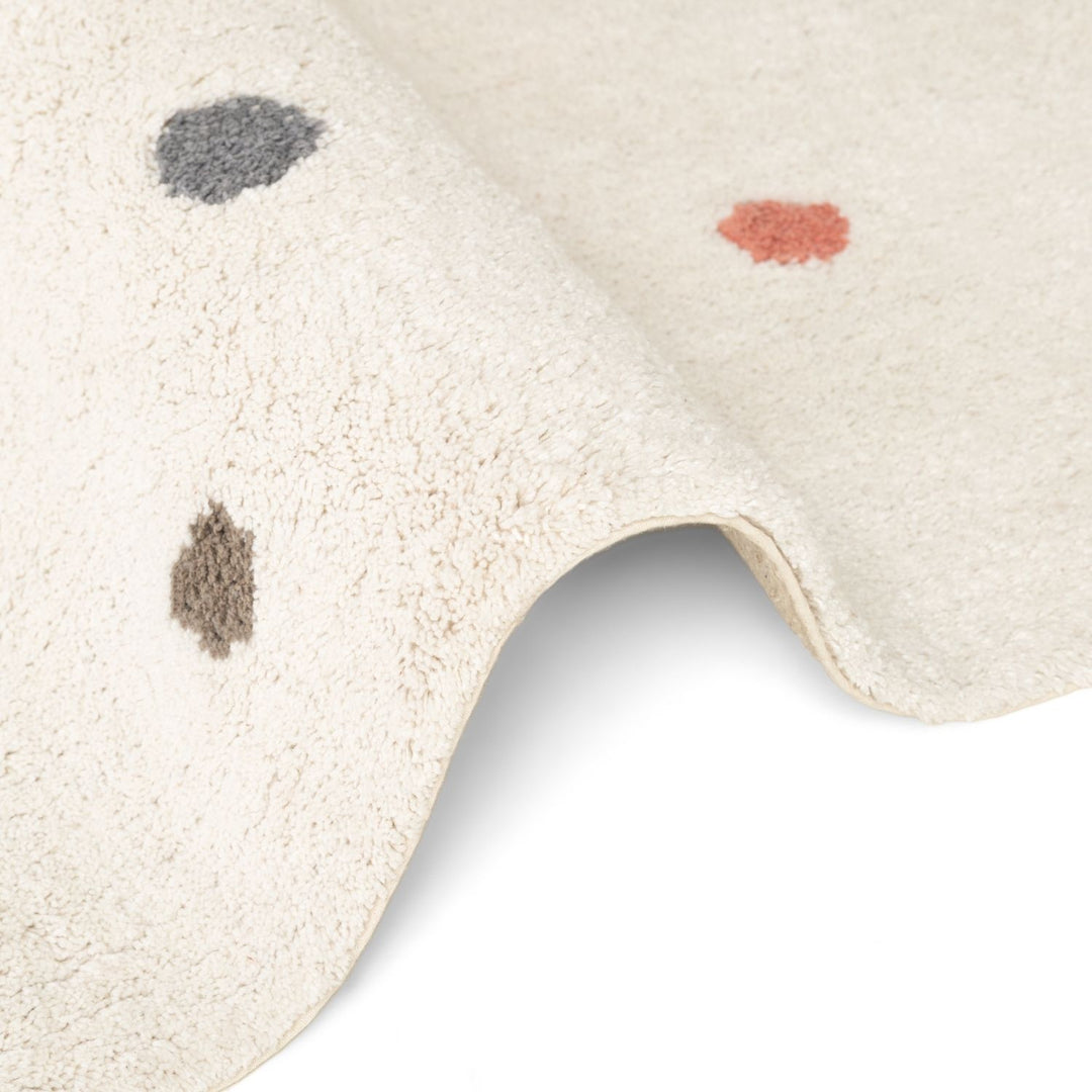 Close-up of a textured rug with abstract patterns on a white background