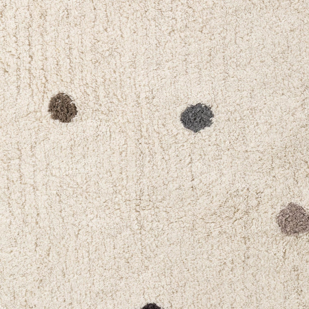 Close-up of beige carpet with dark spots