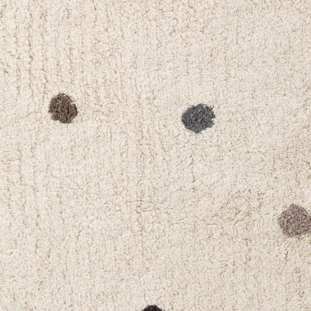 Close-up of beige carpet with dark spots