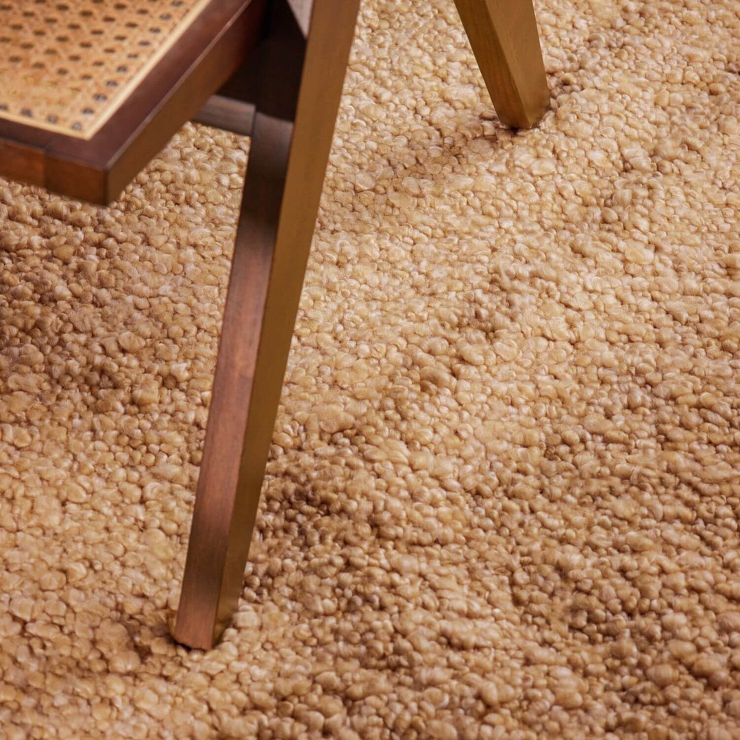 Close-up of a chair leg on a beige carpet