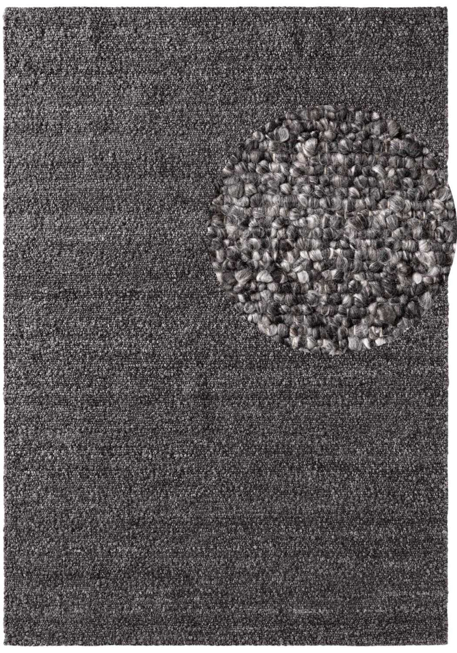 Gray textured rug with a circular patterned border
