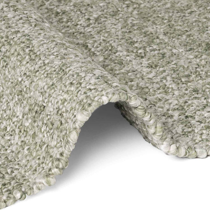 Close-up of textured green carpet on a white background