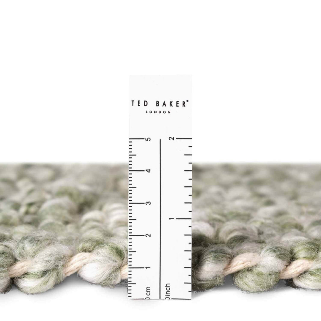 Textured fabric with a ruler for scale and 'Ted Baker London' branding.
