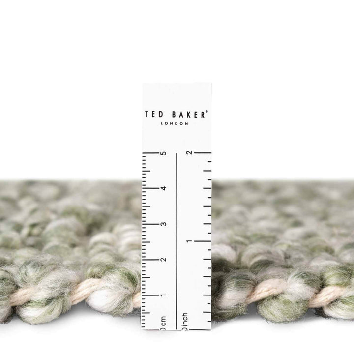 Textured fabric with a ruler for scale and 'Ted Baker London' branding.