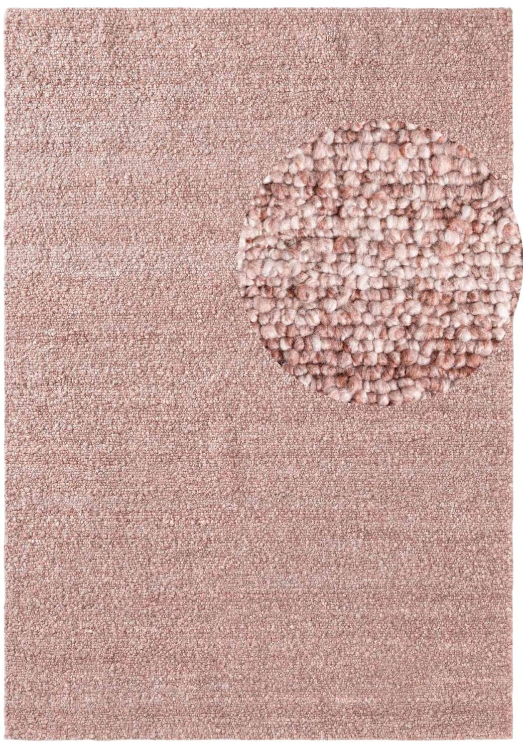 Pink textured rug with a circular patterned area in the center