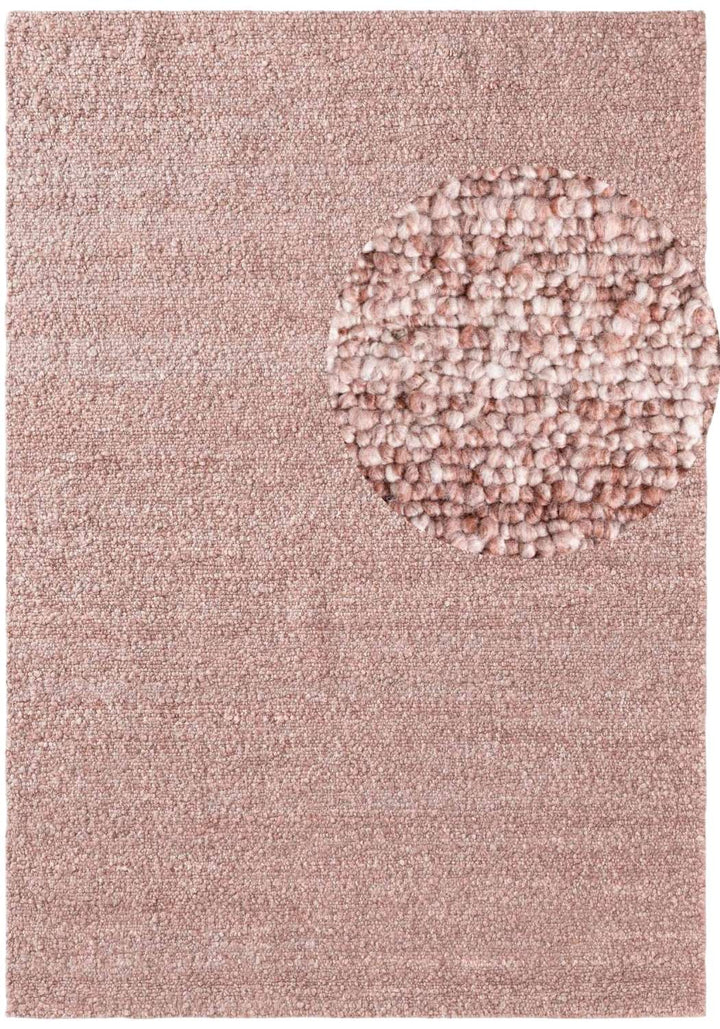 Pink textured rug with a circular patterned area in the center