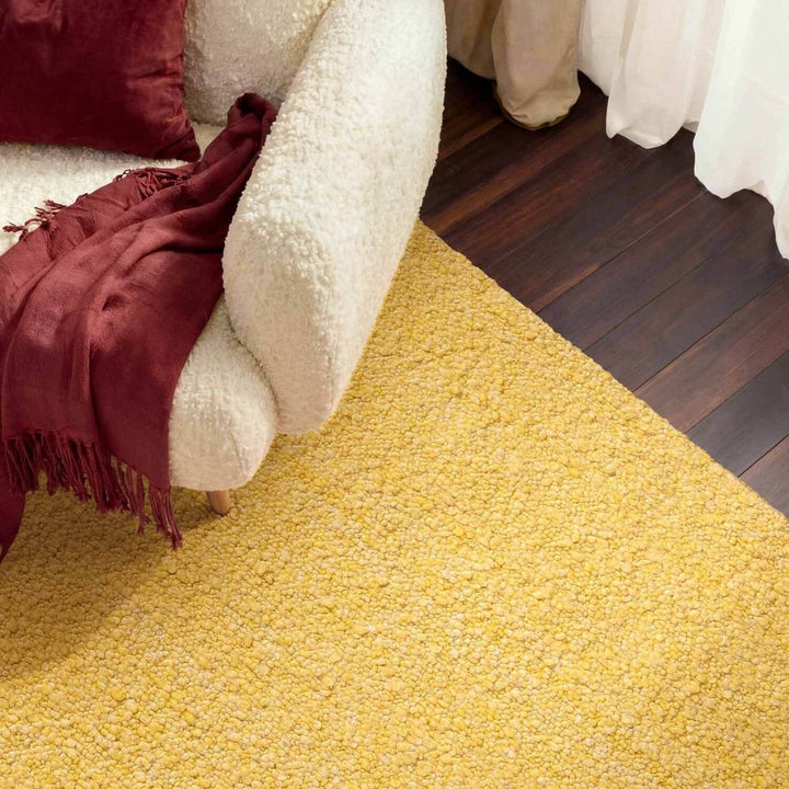 Yellow carpet with a white chair and red blanket in a room.