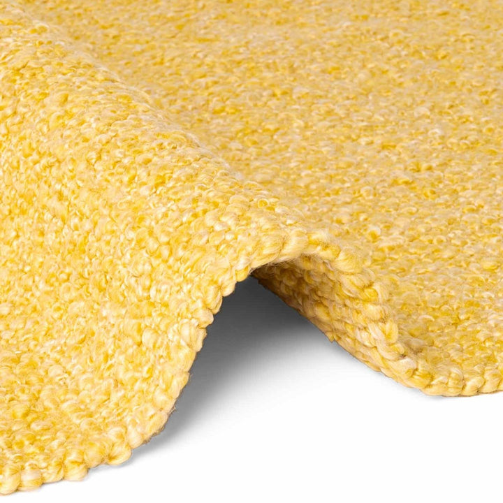 Close-up of a yellow sponge with a textured surface on a white background