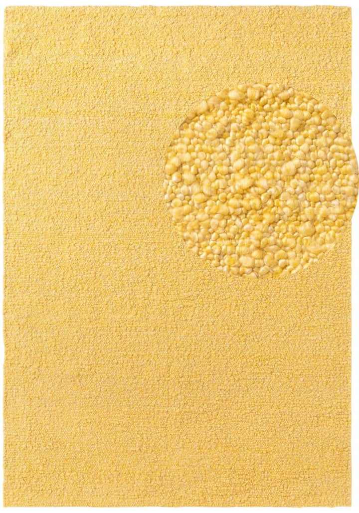 Yellow bath mat with a textured circular design