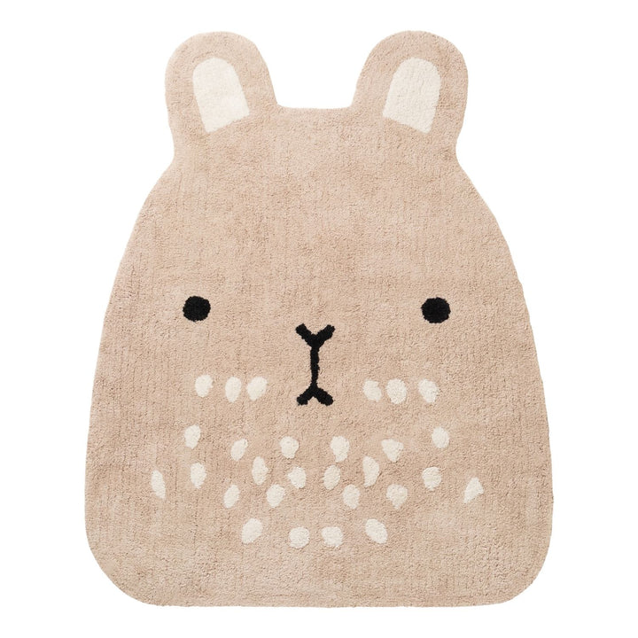 Beige animal-shaped rug with a face design on a white background