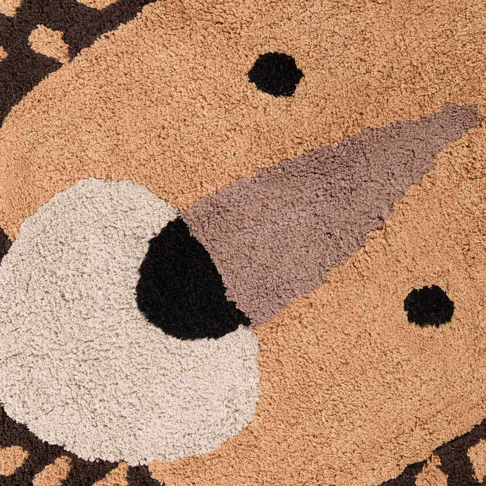 Close-up of a textured doormat with a bear design.