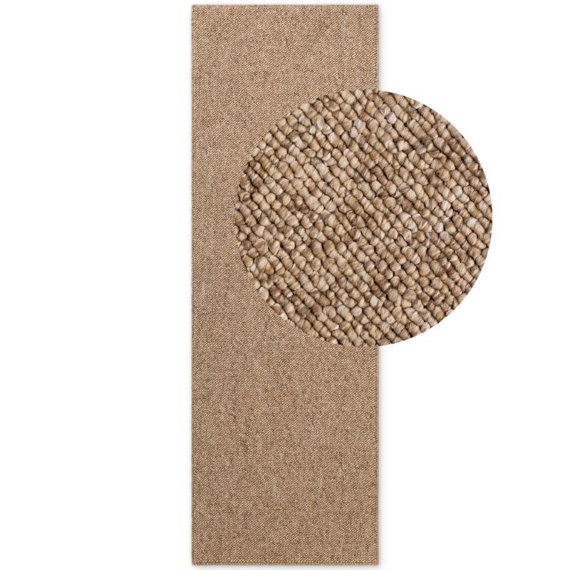 Beige textured rug with a circular detail on a white background