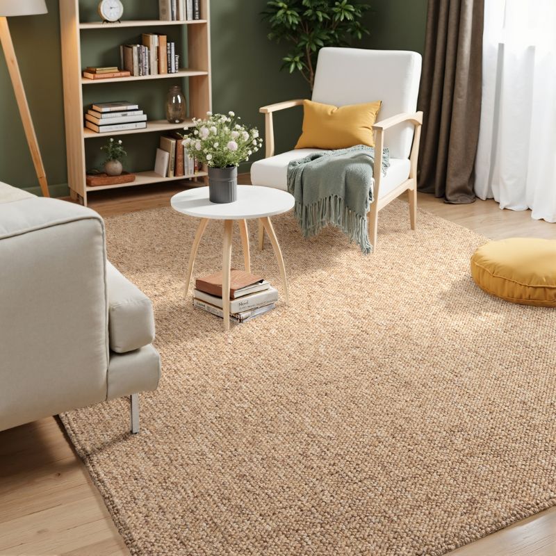 Living room with beige rug, white armchair, and bookshelf.