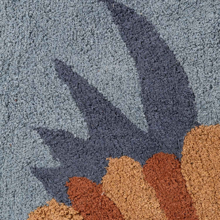 Close-up of a textured rug with blue and brown patterns