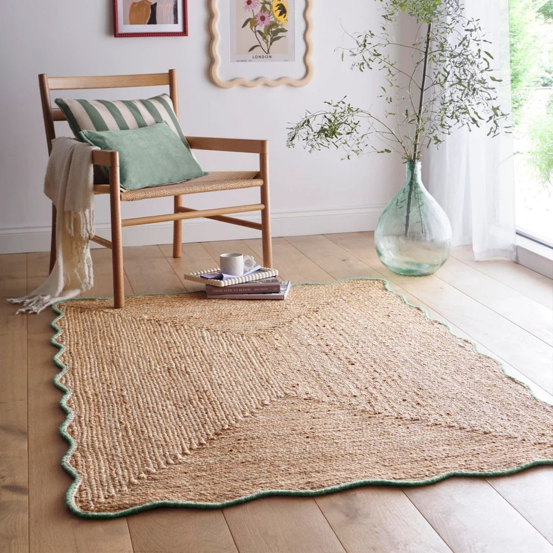 Woven rug on a wooden floor with a chair and decorative elements.
