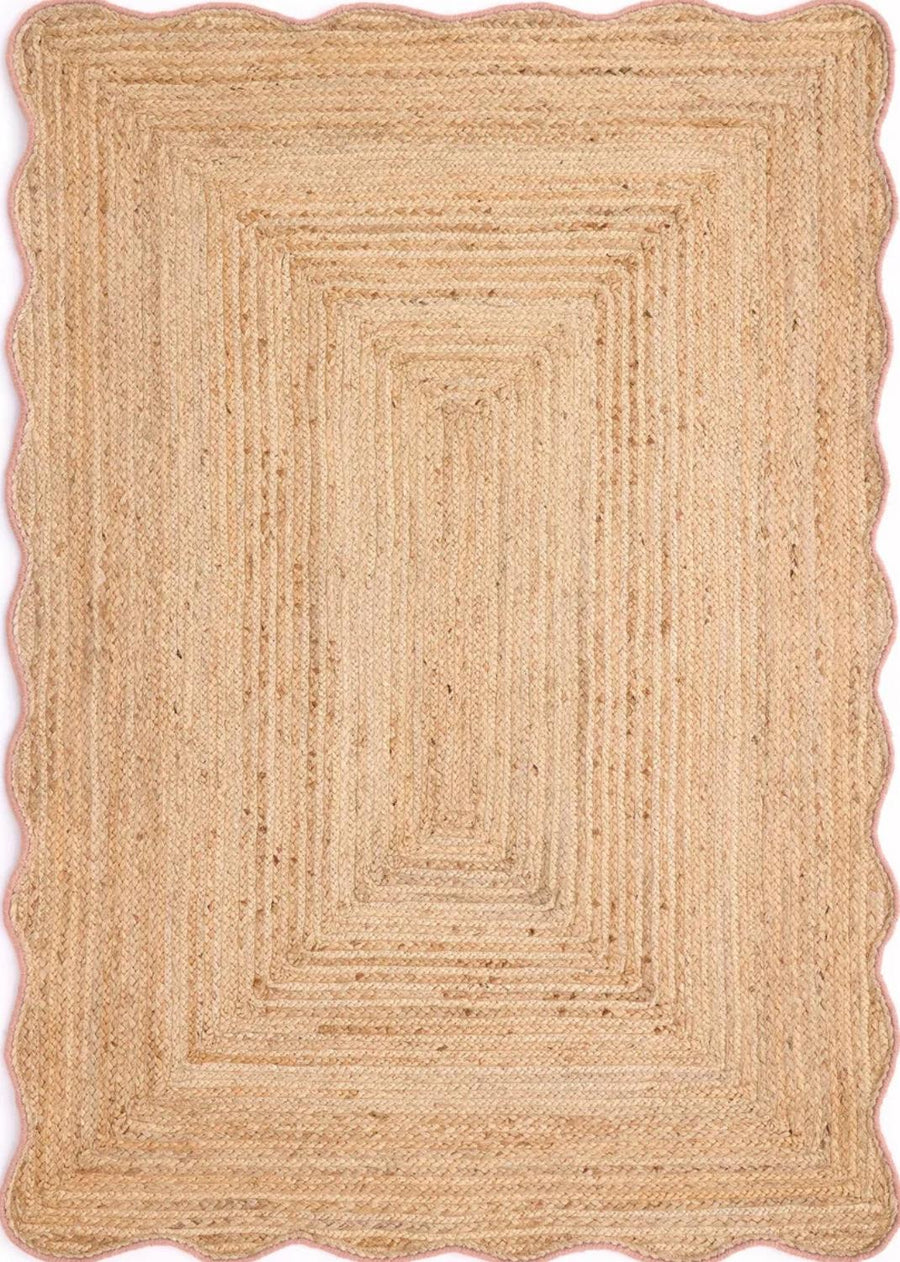 Beige braided rug with scalloped edge on a white background
