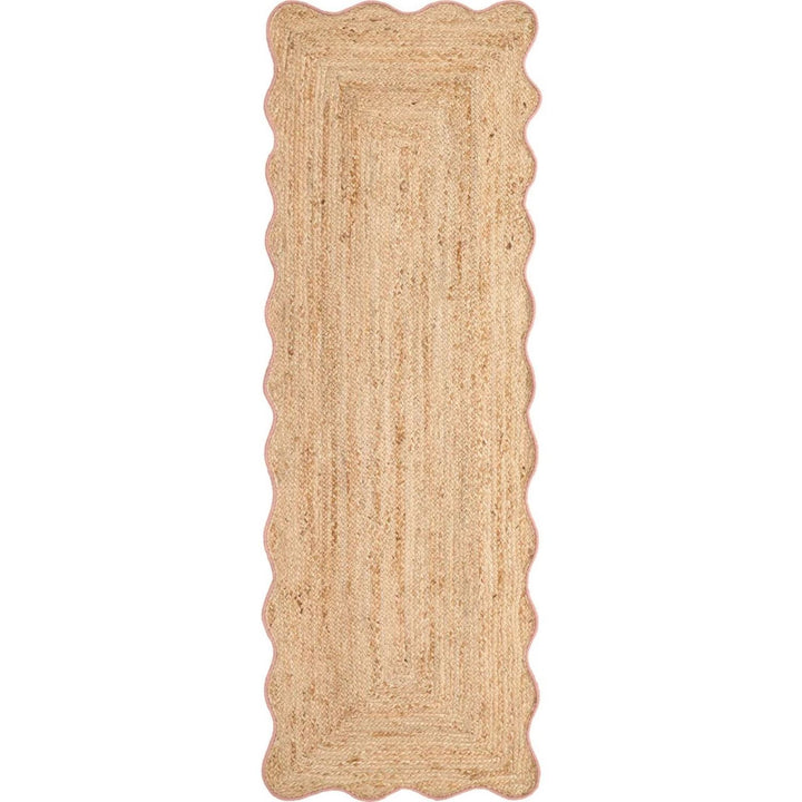 Beige braided rug with scalloped edges on a white background