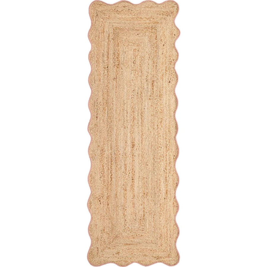 Beige braided rug with scalloped edges on a white background