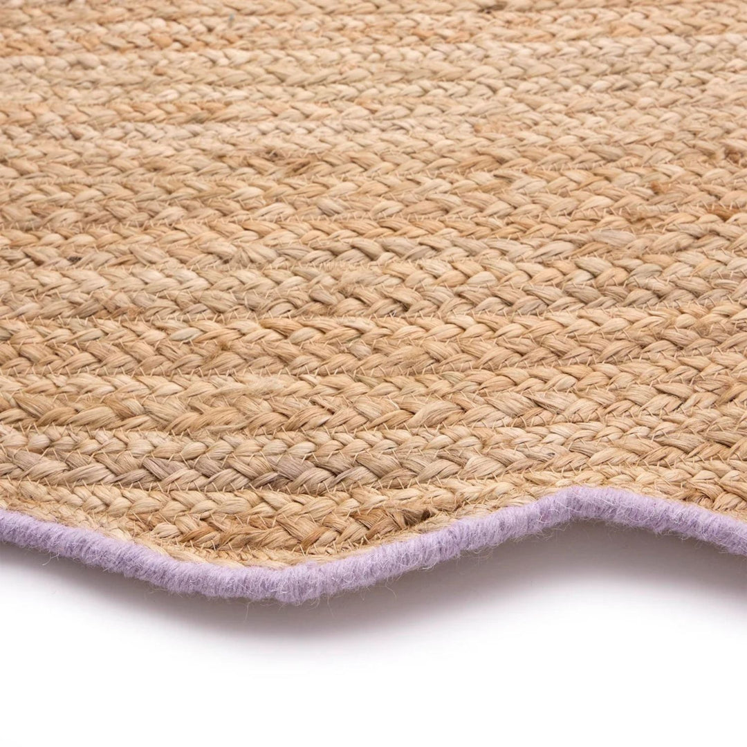 Close-up of a woven mat with a purple border on a white background