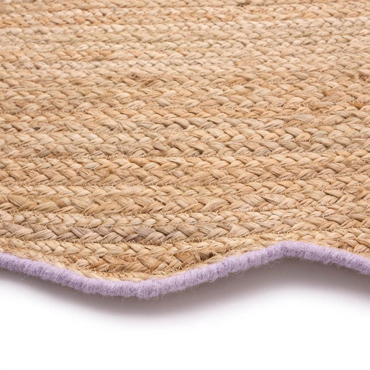 Close-up of a woven mat with a purple border on a white background