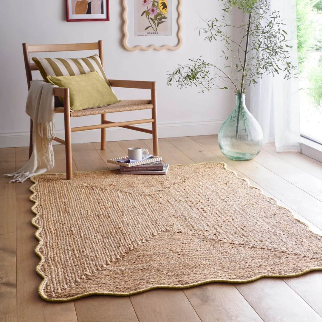 Woven jute rug on a wooden floor with a chair and decorative elements.
