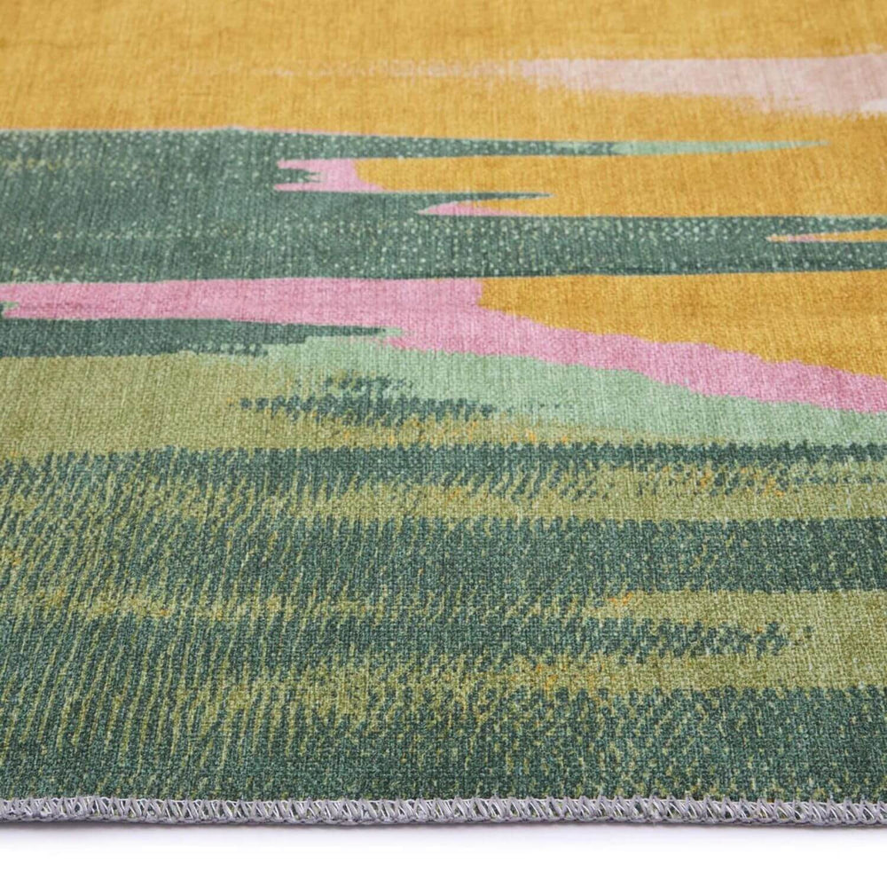 Close-up of a multicolored woven fabric with green, pink, and yellow patterns.