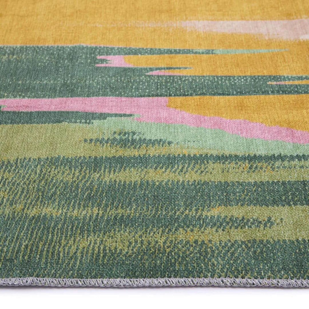 Close-up of a multicolored woven fabric with green, pink, and yellow patterns.