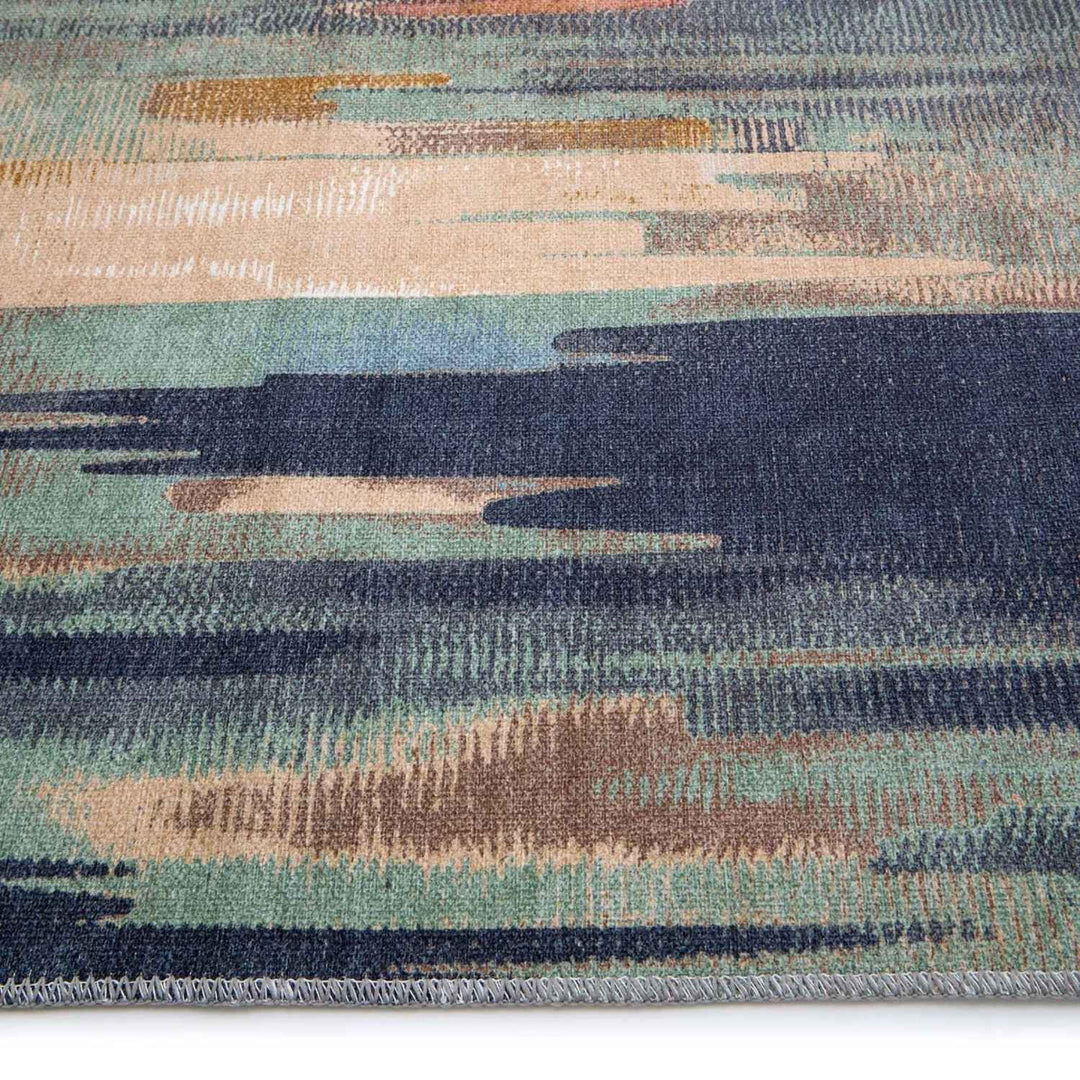 Close-up of a textured rug with blue, green, and brown pattern