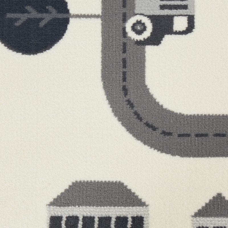 Close-up of a patterned rug with vehicles and roads on a neutral background