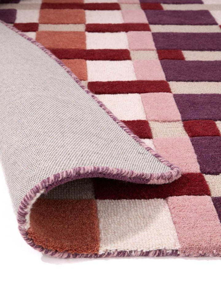 Hand-carved multicolour geometric wool rug showcasing texture and block design, ideal for modern interiors.