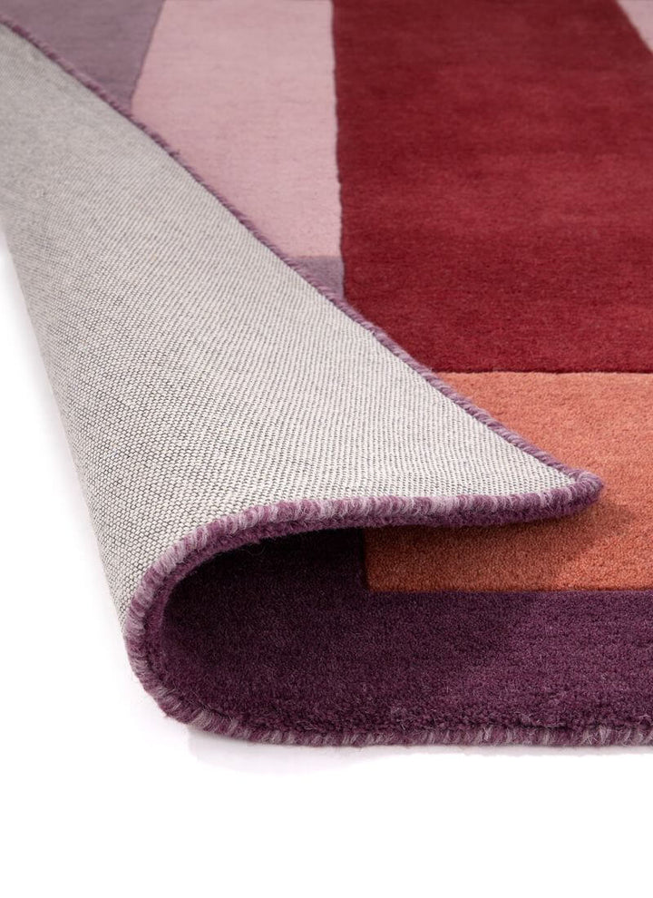 Corner view of a multicolour hand-carved geometric rug showcasing cut and loop pile texture.