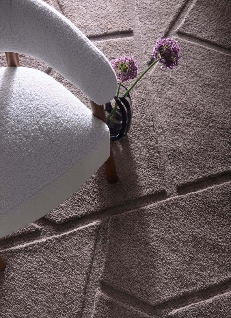 Scandinavian deep pile cream and grey rug with a cozy chair and flowers, perfect for modern interiors.