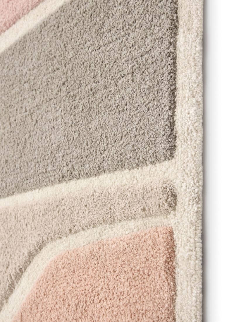 Close-up of Strata Abstract Rug showing soft touch deep pile and modern color patterns in Terra and Pink/Grey.