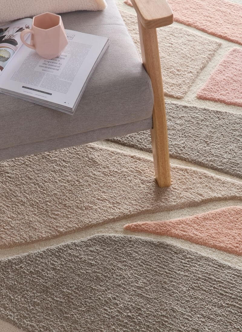 Strata Abstract Rug in soft pink and grey tones, featuring a deep pile, enhancing cozy home decor.