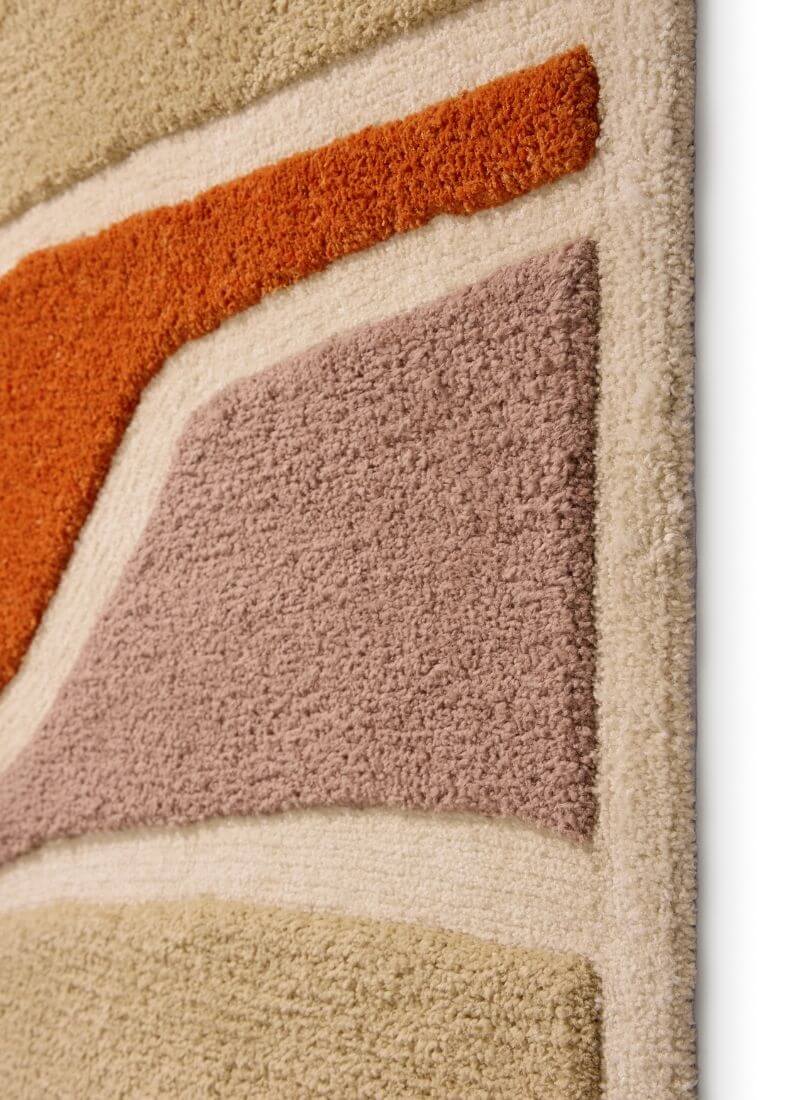 Close-up of the Strata Abstract Rug showing soft touch deep pile in warm Terra and Pink/Grey colors.