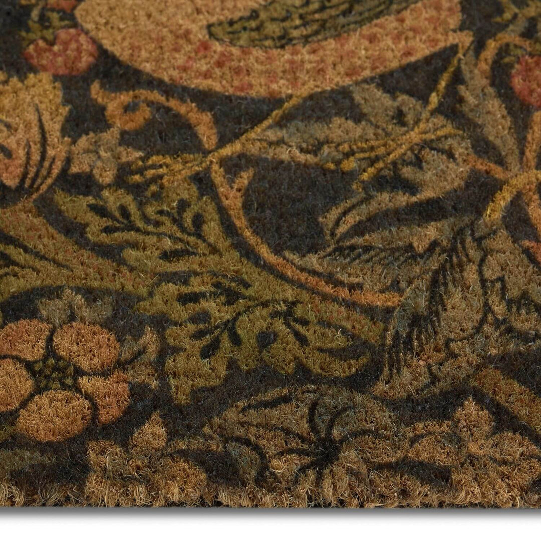 Close-up of a textured fabric with floral and leaf patterns