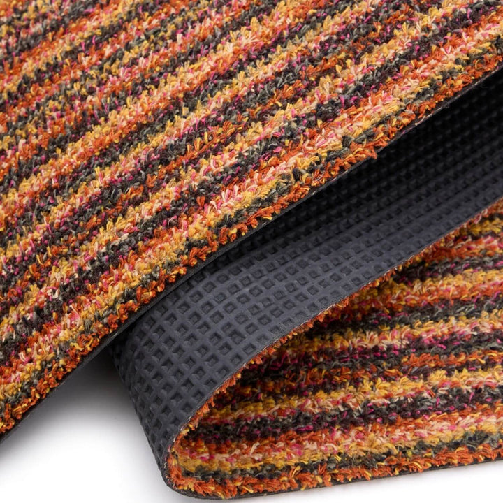 Multicolored textured mat with a black rubber backing