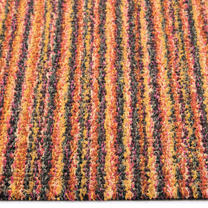 Close-up of a multicolored striped fabric with orange, yellow, and red hues.