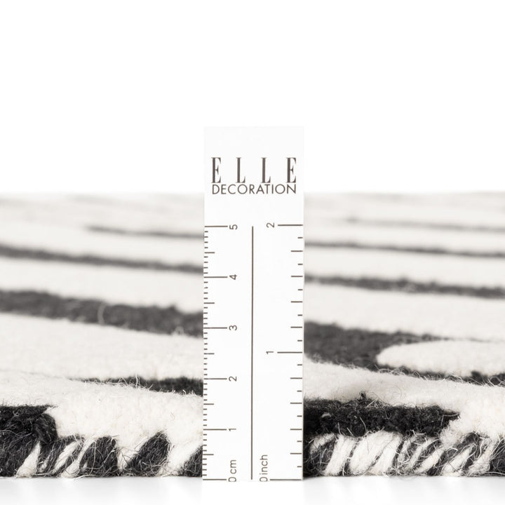 Textured black and white fabric with a ruler for scale on a white background, featuring the 'ELLE Decoration' brand.