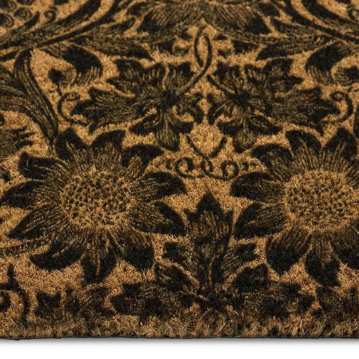 Close-up of a brown doormat with floral patterns