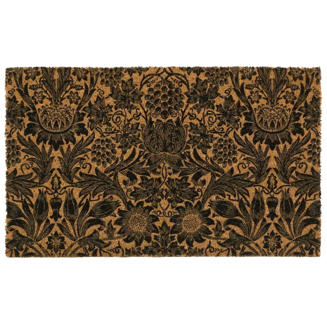 Floral patterned doormat with black design on a beige background