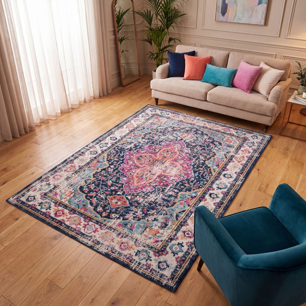 Living room with a patterned rug, sofa, and blue chair.