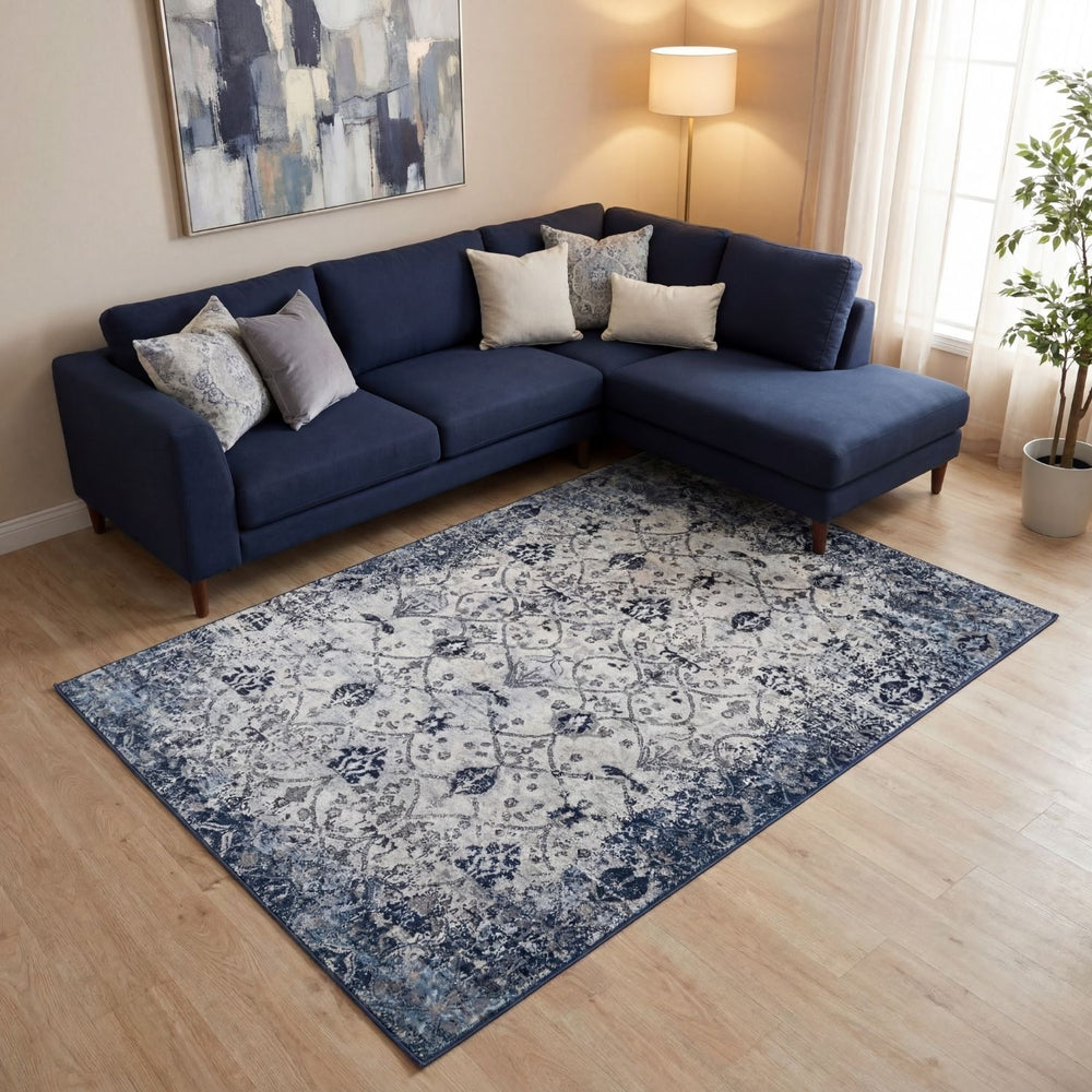 Navy blue sectional sofa with decorative pillows in a living room setting.