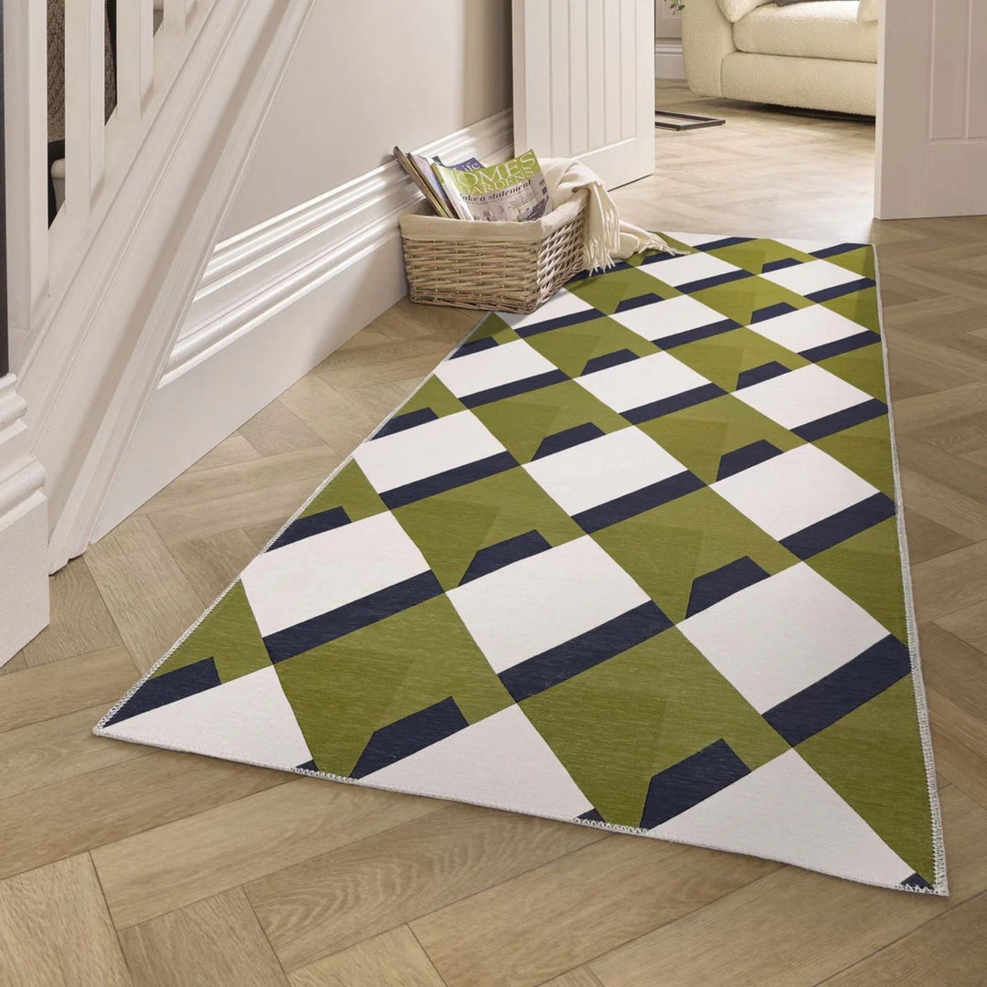 Geometric patterned rug on a wooden floor with a basket and books in the background.
