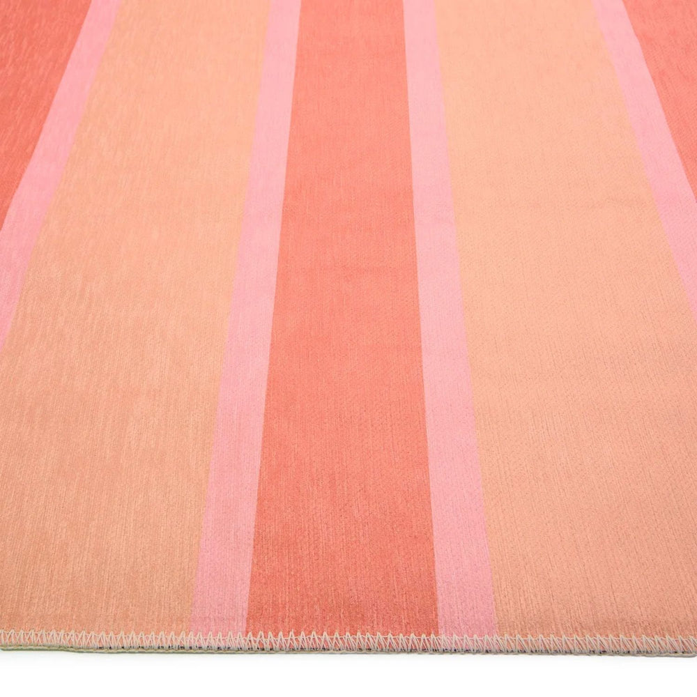 Close-up of a fabric with pink and peach stripes