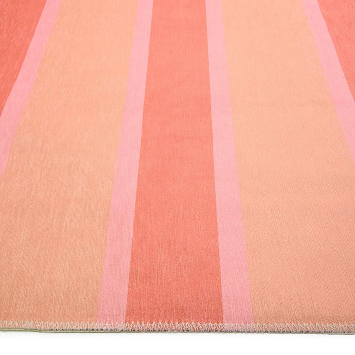 Close-up of a fabric with pink and peach stripes
