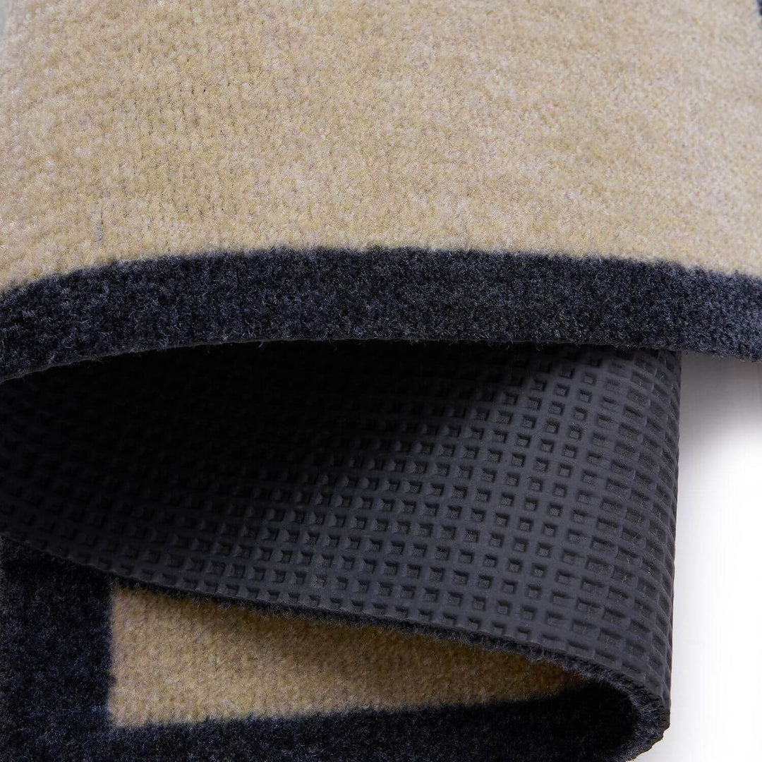 Close-up of a folded fabric with beige, black, and gray colors.
